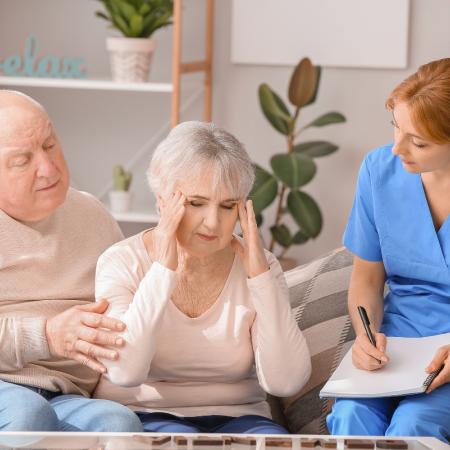 Caregiver assessing senior with dementia 
