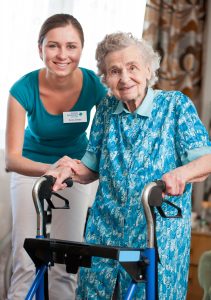 Caregiver with lady on walker