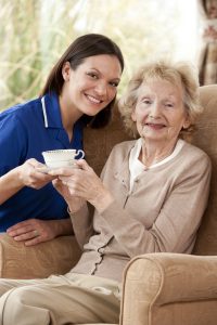 Caregiver with senior lady at tea time