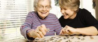 PSW helping senior lady with puzzle