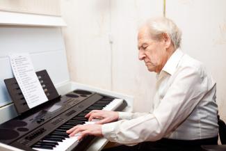 Senior man playing piano