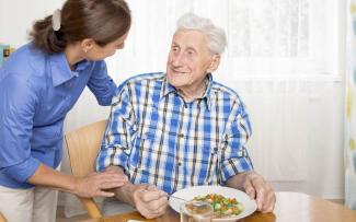 Dementia patient eat food from care giver