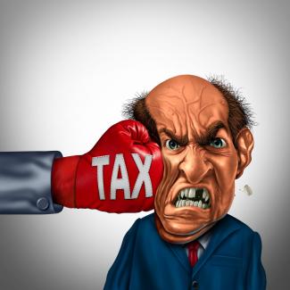 Cartoon of man punched in face by taxes