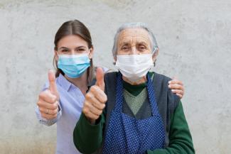 Nurse with senior in masks