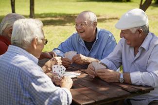 Seniors playing cards in park