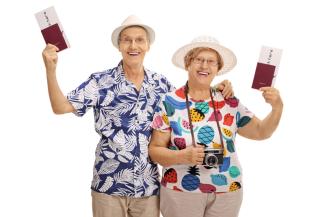 Senior couple smiling with passports