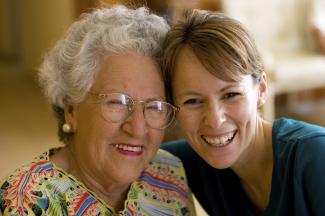 Senior lady and caregiver smiling