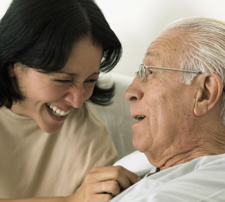 Senior man smiling at his care giver