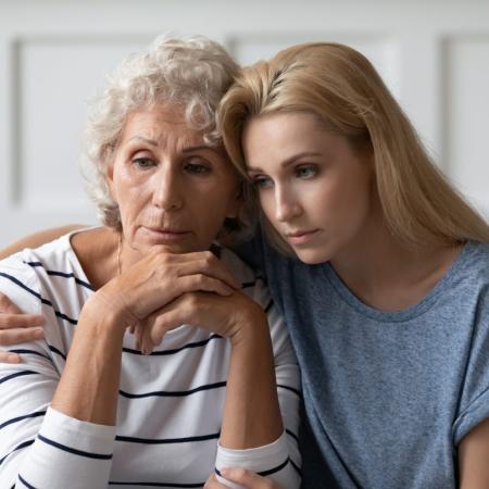 Young woman consoling senior