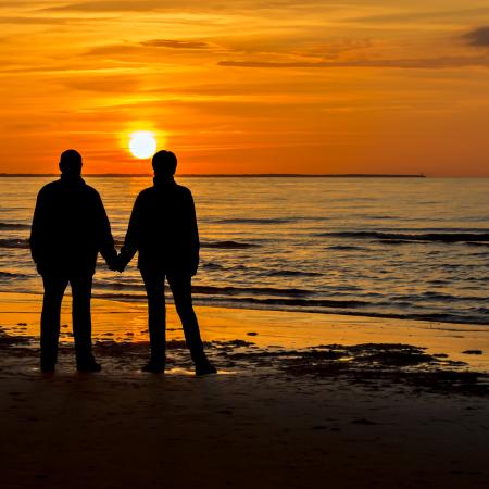 Couple at sunset holding hands