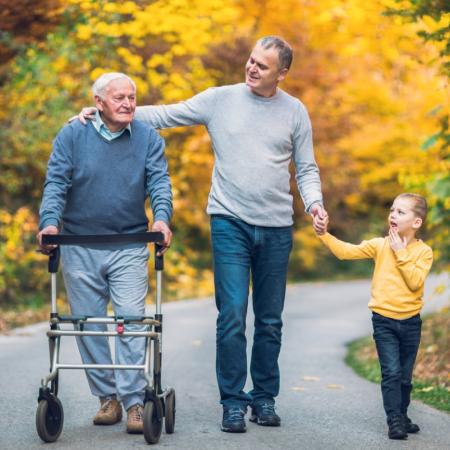 Elderly father, son and grandson out for a walk