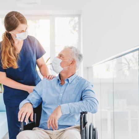 Nurse explaining information to patient in wheelchair
