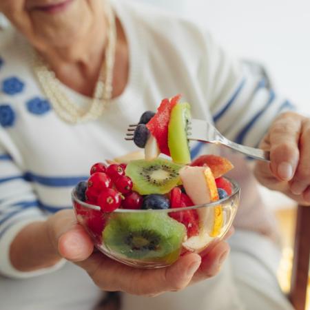 Senior woman with bowl of fruit