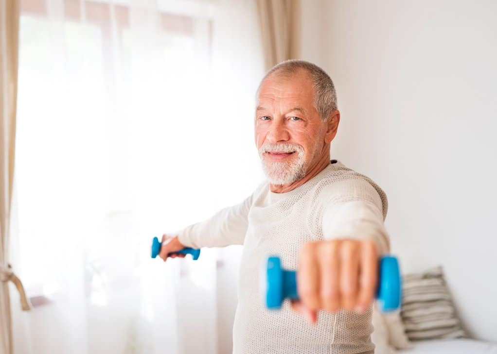 Senior staying active and exercising indoors during the fall/winter
