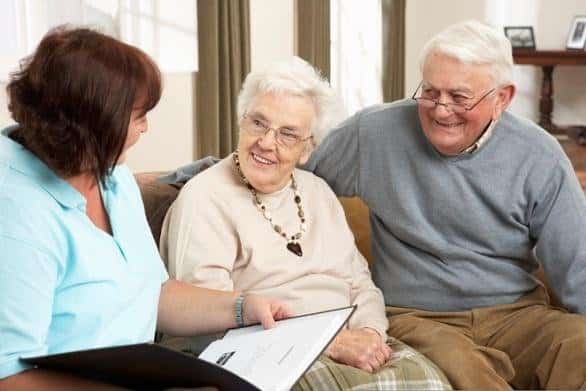 Senior couple with home care agency staff